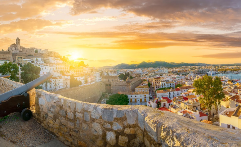 Scenic view of Dalt Vila in Ibiza at sunset, home to the IMS Ibiza music festival. This luxury music event offers an immersive music and culture travel experience, attracting discerning travelers seeking high-end vacations centered around music festivals.