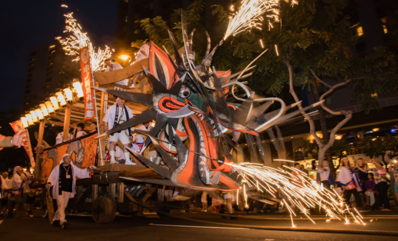 Spectacular float with fireworks at the Honolulu Festival in Oahu, a cultural luxury travel event showcasing traditional performances, music, and artistic heritage from across the Pacific.