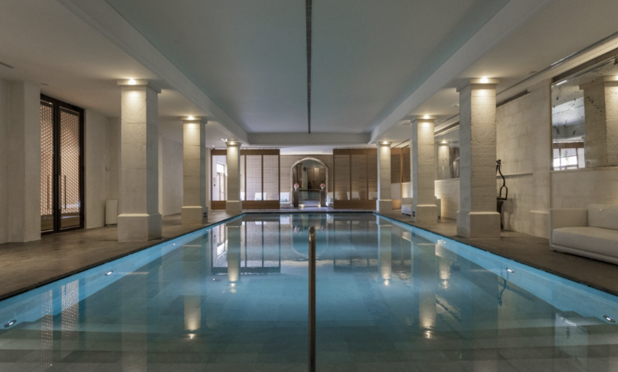 The Spa at Coquillade Provence  Alt Text: Coquillade Provence Resort & Spa’s softly lit indoor pool creates a tranquil and inviting environment for discerning guests.