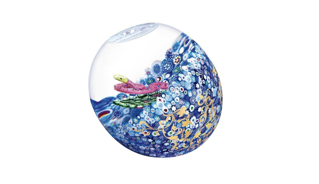 This exquisite glass paperweight features a golden snake surrounded by intricate millefiori patterns.