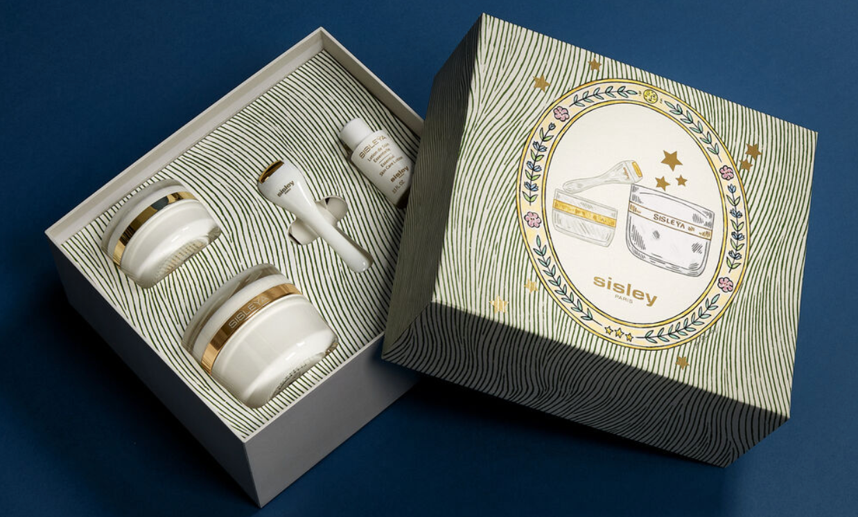 Elegant Sisleÿa skincare collection gift set within a luxurious, artistically illustrated box.