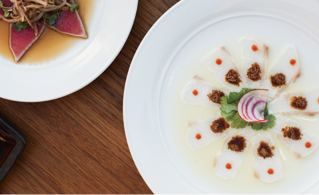 A top-down view of two delectable seafood plates.