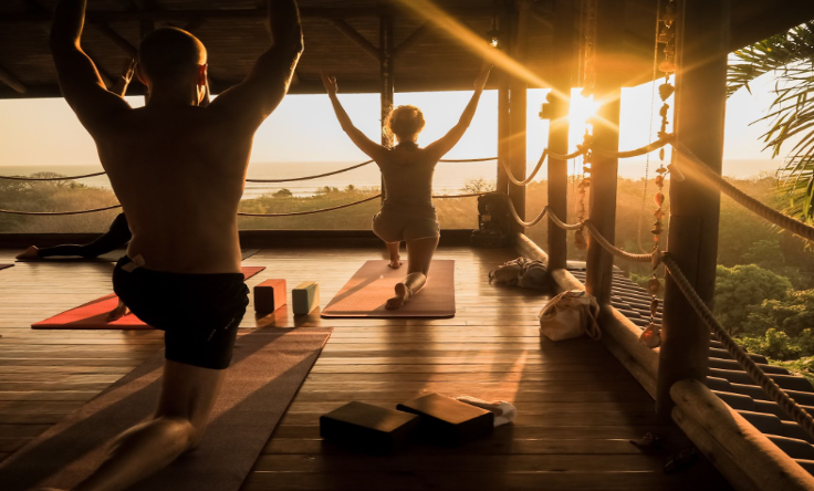 Sunrise yoga in Santa Teresa, where luxury wellness retreats meet nature’s tranquility, offering a moment of balance above the Pacific.